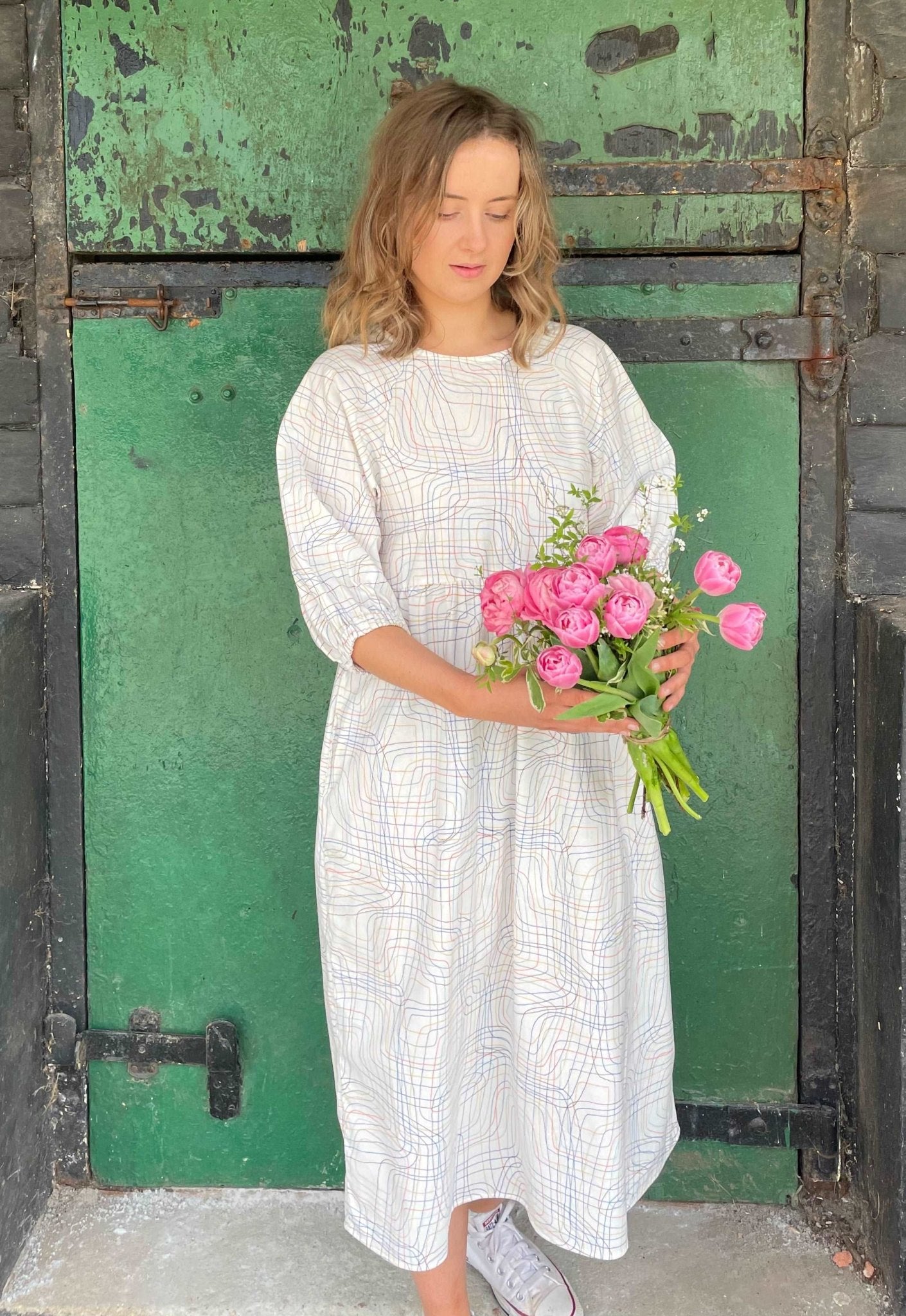 model wearing cream ley lines Kay dress holding a bouquet