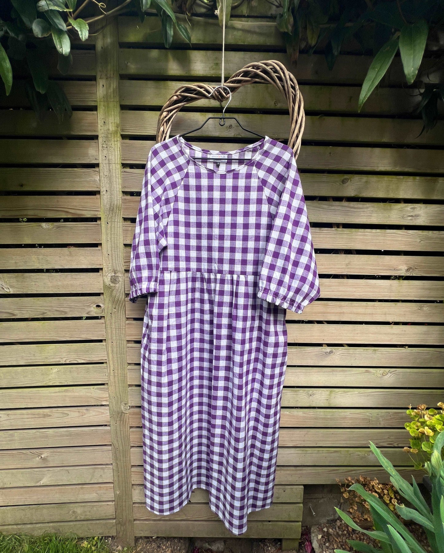 Purple gingham kay dress on a hanger sustainable dresses UK