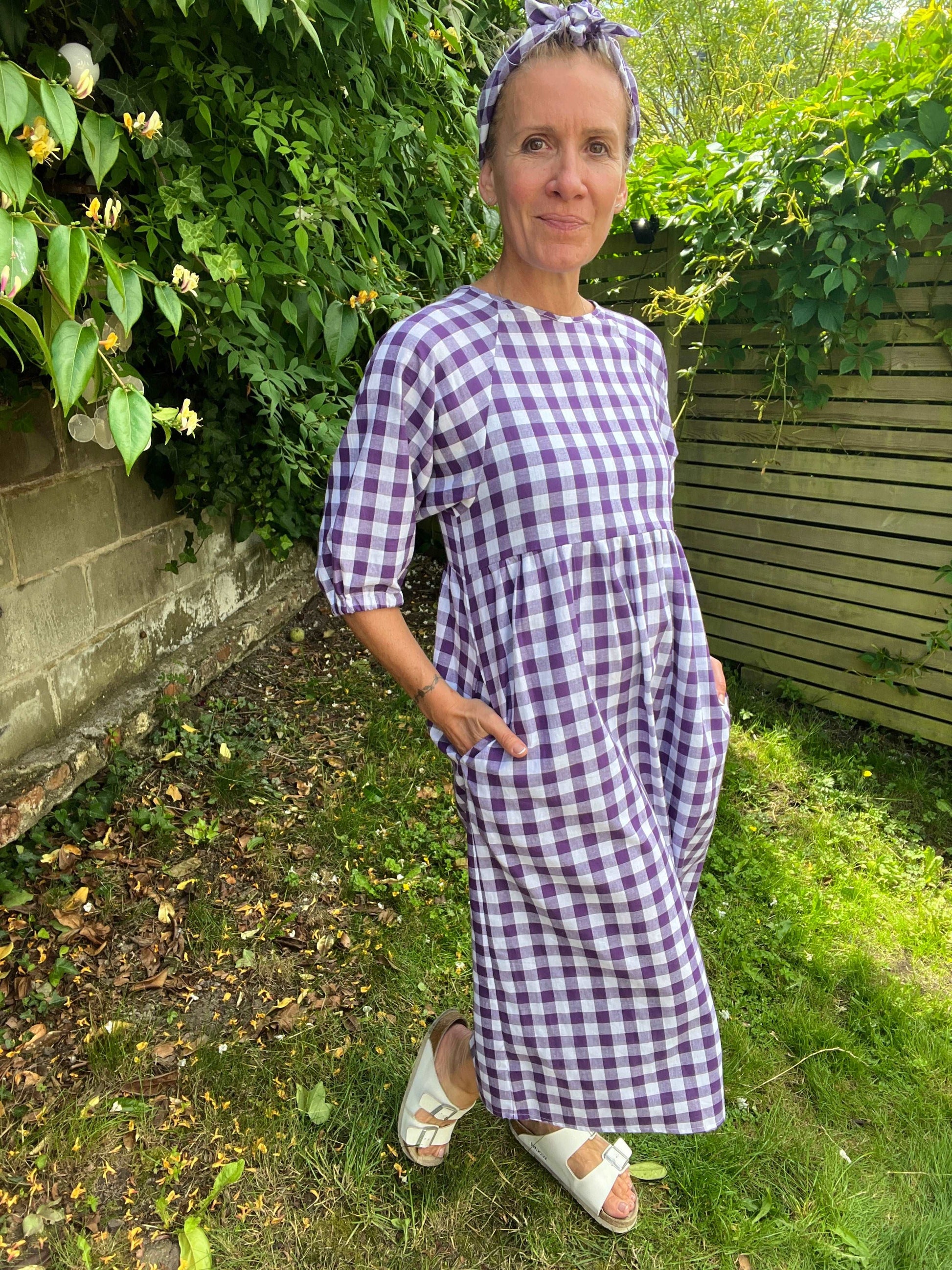 purple gingham dress with pockets modelled sustainable dresses UK