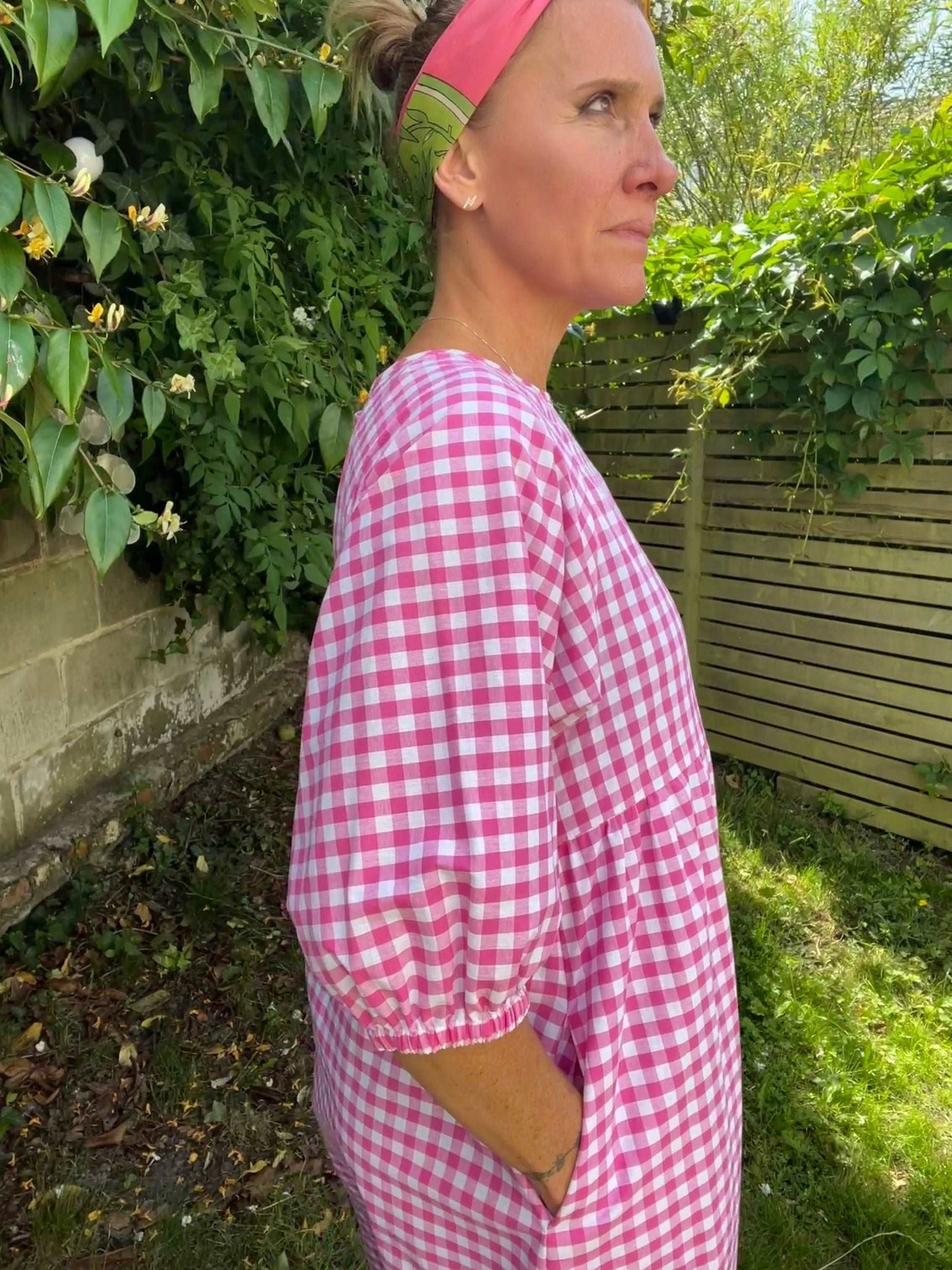 Side view of pink gingham dress with pockets sustainable dresses UK