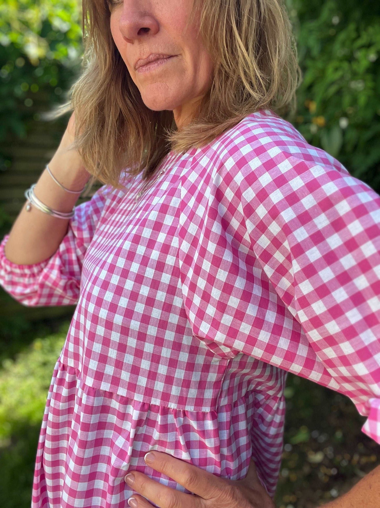 model wearing pink gingham kay dress side view sustainable dresses UK