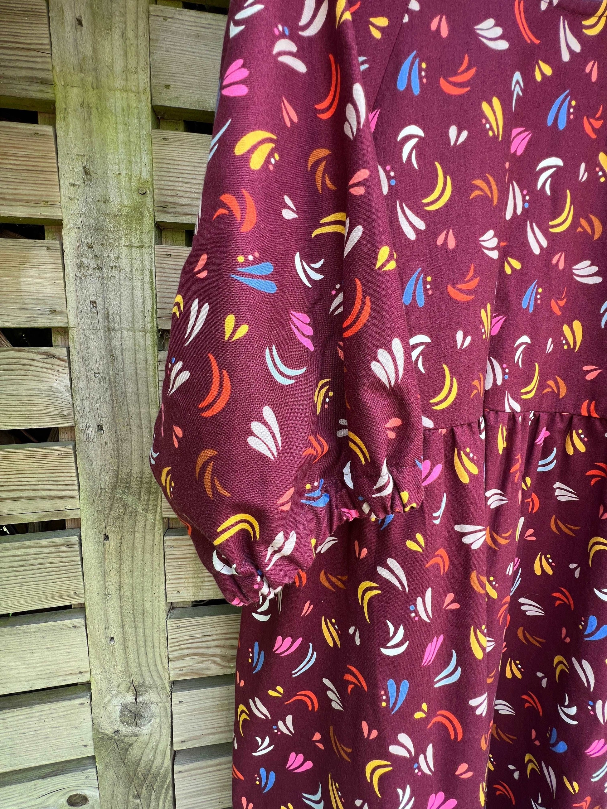 sleeve close up of Kay dress in maroon fiesta