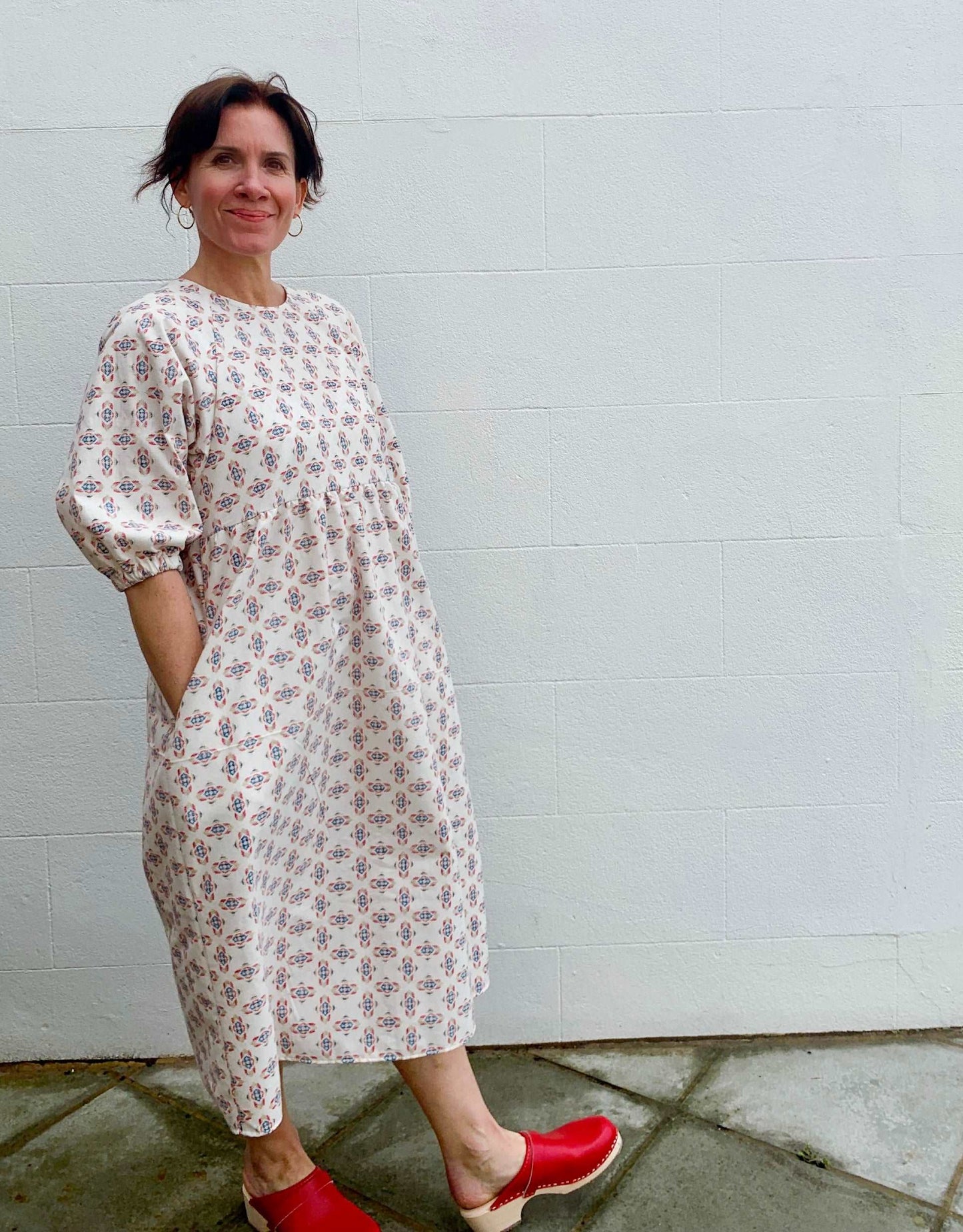 Cream brushed cotton dress with pockets wearing red clogs
