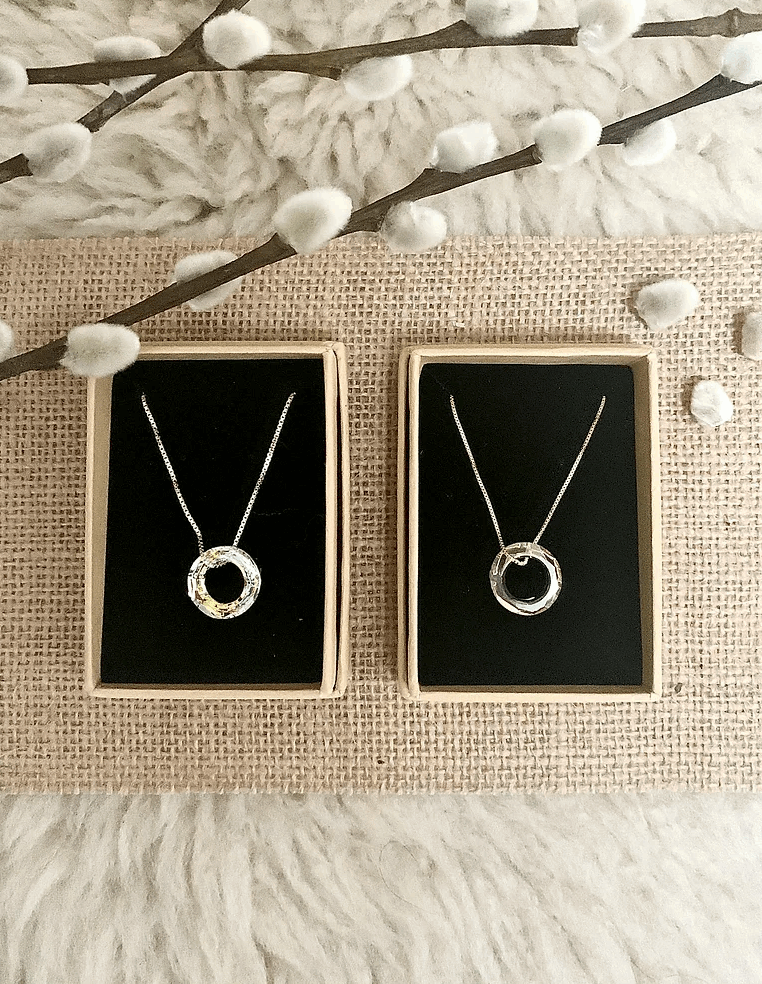 A duo of crystal circle necklaces in boxes