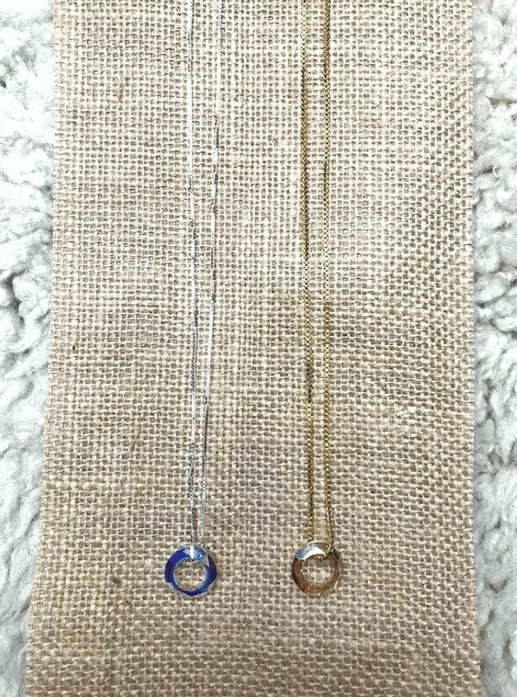 silver and gold necklaces displayed dide by side